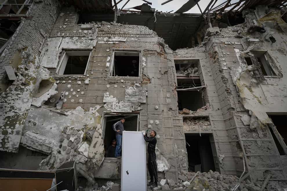 Local residents inspect heavily damaged buildings after a Russian rocket attack in Kharkiv, Ukraine (Andrii Marienko/AP)