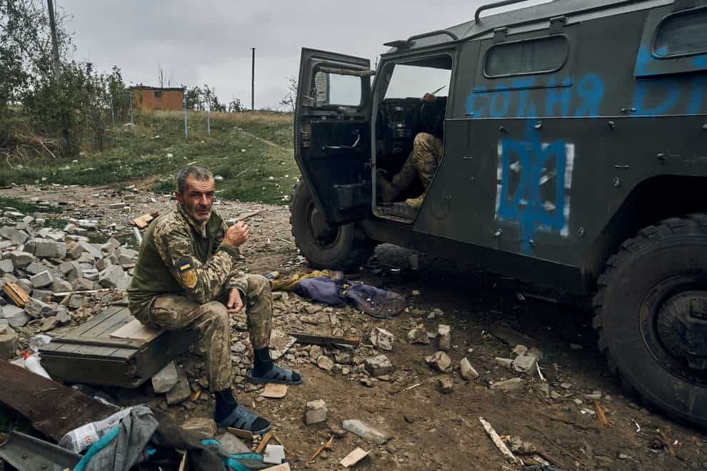 A Ukrainian soldier takes a break to rest in the freed territory in the Kharkiv region (Kostiantyn Liberov/AP)