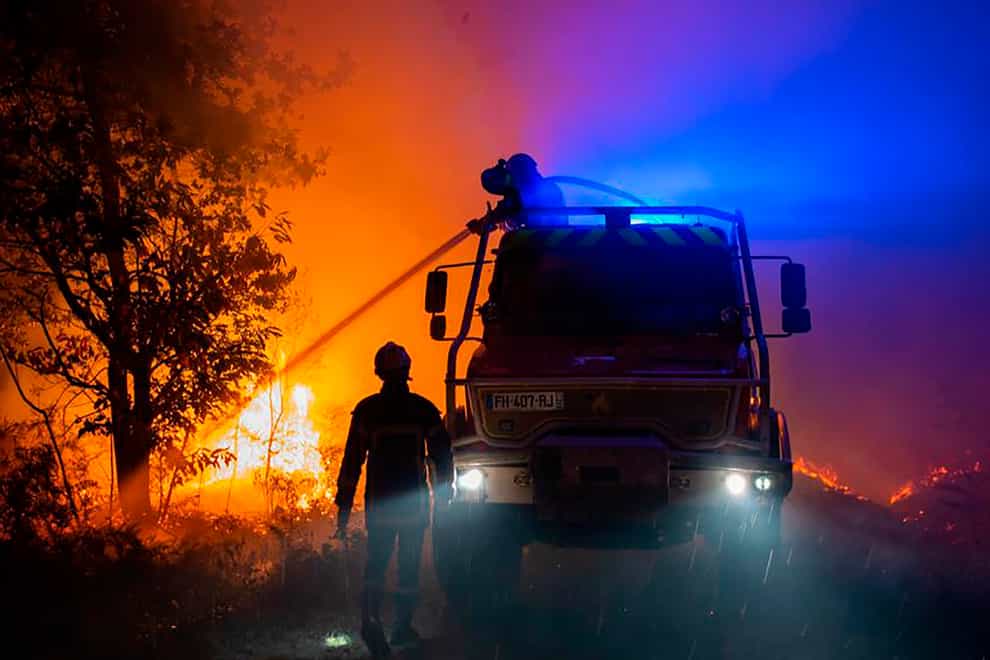 Firefighters battle a wildfire near the village of Saumos (SDIS33 via AP)