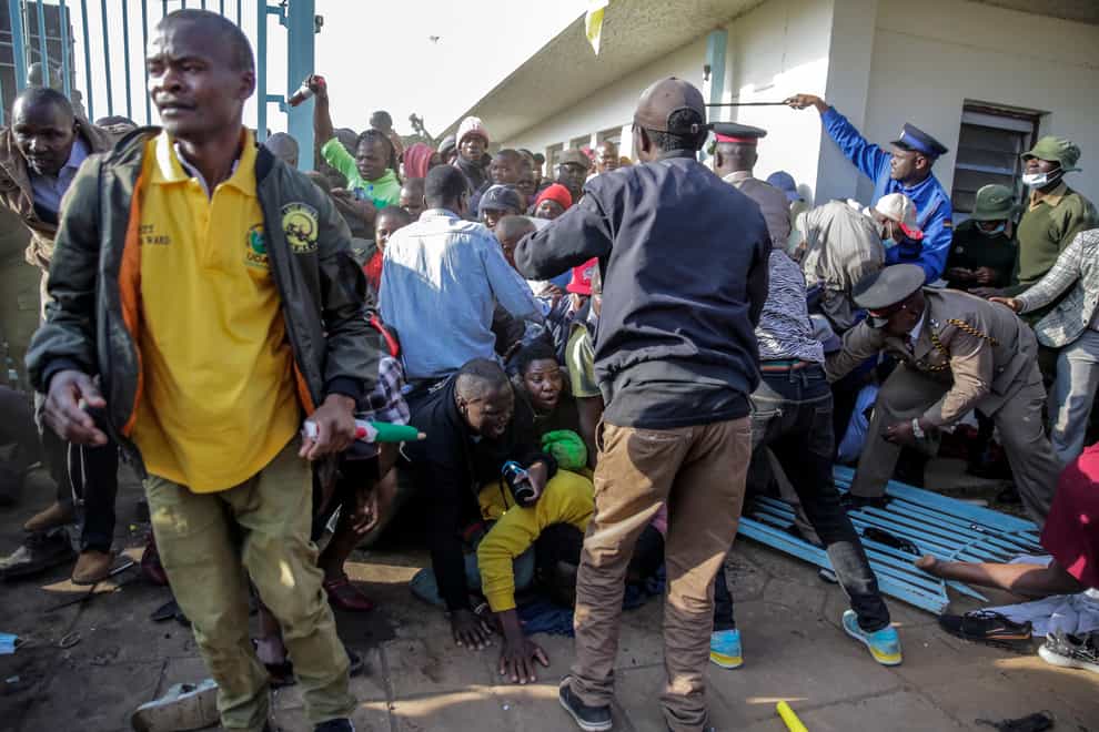 People are crushed in a stampede as security forces attempt to push them back (/Brian Inganga/AP)