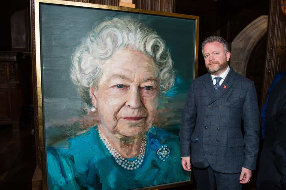 Artist Colin Davidson with his portrait of the Queen displayed at a Co-operation Ireland reception (Jeff Spicer/PA)