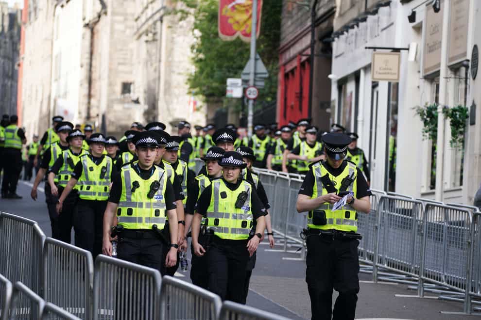 Police officers on the Royal Mile in Edinburgh following the Queen’s death (Peter Byrne/PA)
