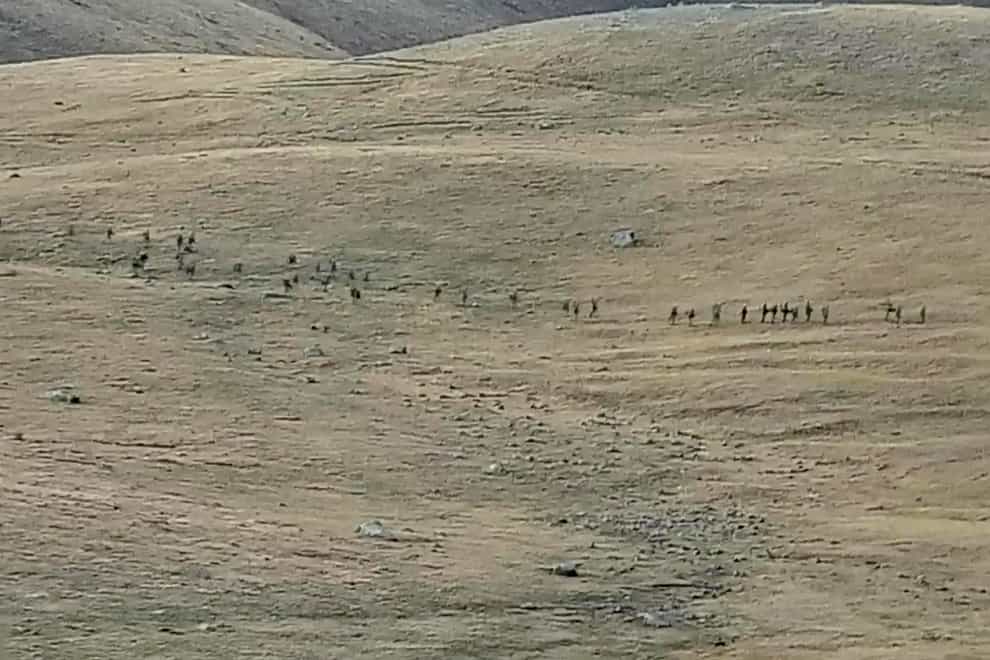 This image taken from a YouTube footage released by Armenian Defense Ministry on Tuesday, Sept. 13, 2022, shows Azerbaijanian servicemen crossing the Armenian-Azerbaijani border and approaching the Armenian positions. Armenia’s prime minister says that 49 soldiers have been killed in nighttime attacks by Azerbaijan. (Armenian Defense Ministry via AP)
