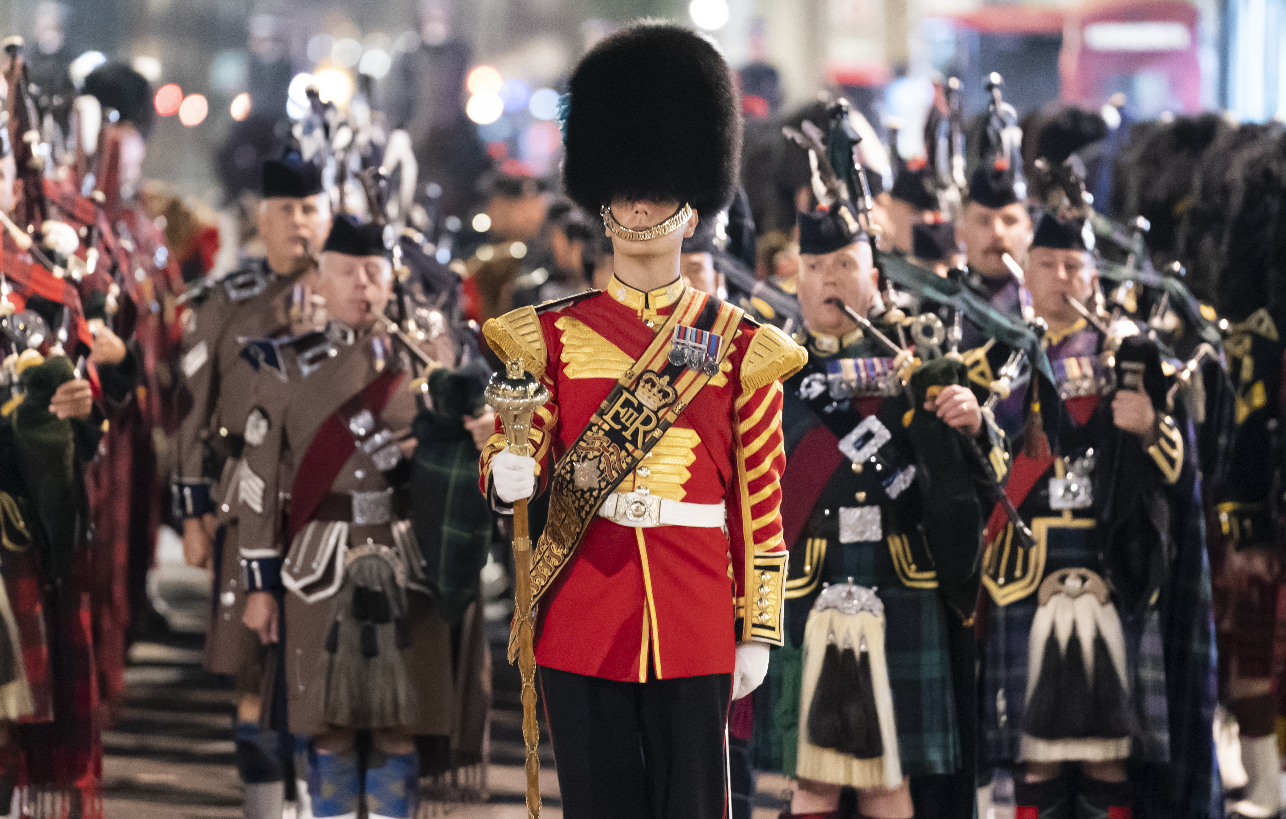 <p>The sound of bagpipes began at 2.45am, signalling the start of the procession (Danny Lawson/PA)</p>