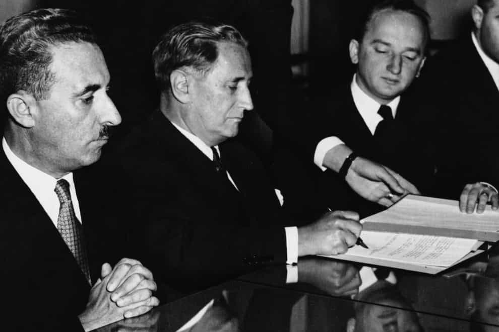 Nahum Goldman, President of the Jewish Claims Commission, centre, signs agreements between Germany and Israel in a ceremony in Luxembourg on September 10 1952 (AP)