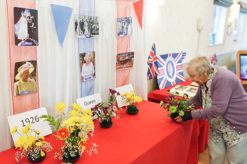 Vera Wren, 90, a resident of The Lawn care home in Alton, Hampshire, where residents have decorated a table with photographs of the Queen, bunting and their own flower arrangements (Friends of the Elderly/PA)