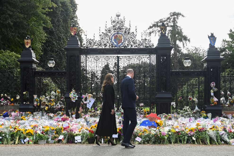 The Prince and Princess of Wales view the floral tributes at Sandringham (Toby Melville/PA)