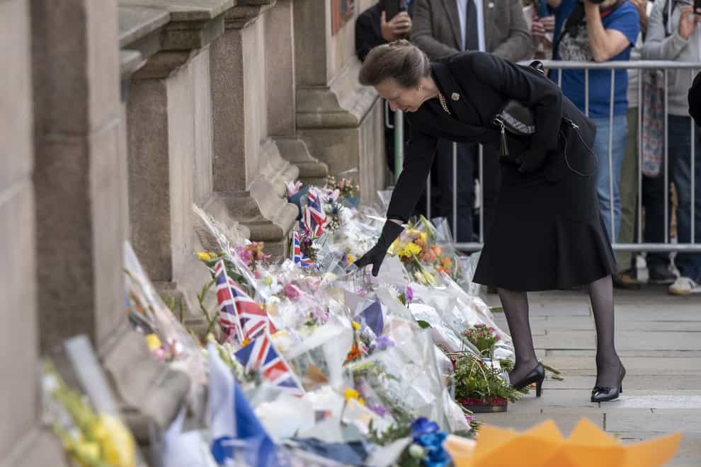 The Princess Royal looks at floral tributes during a visit to Glasgow City Chambers (John Linton/PA)