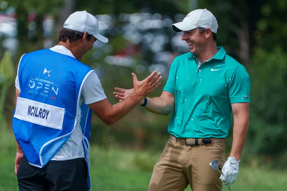 Rory McIlroy (right) is congratulated by his caddie Harry Diamond after his eagle during the first round of the Italian Open (Domenico Stinellis/AP)