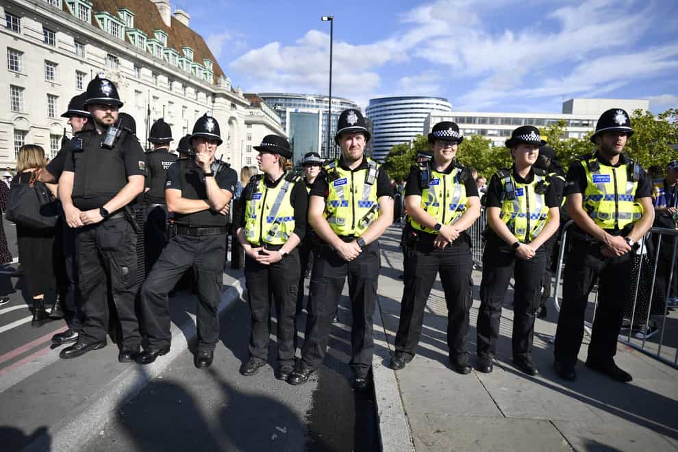 Police with members of the public who are waiting in line in central London, to view Queen Elizabeth II lying in state (Beresford Hodge/PA)