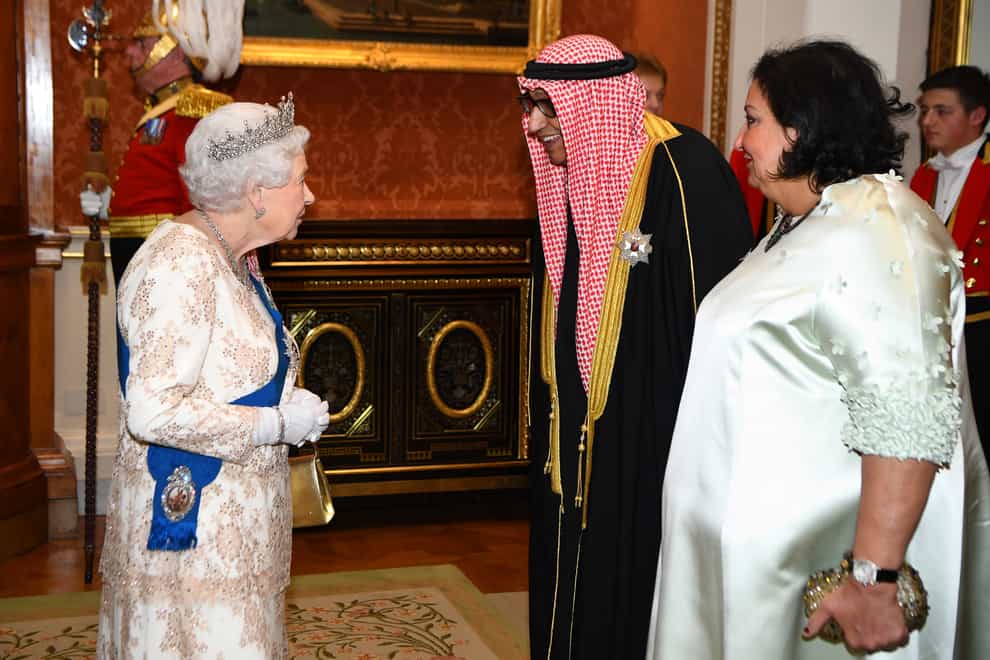 Queen Elizabeth II greets the ambassador of Kuwait at an evening reception for members of the Diplomatic Corps (PA)