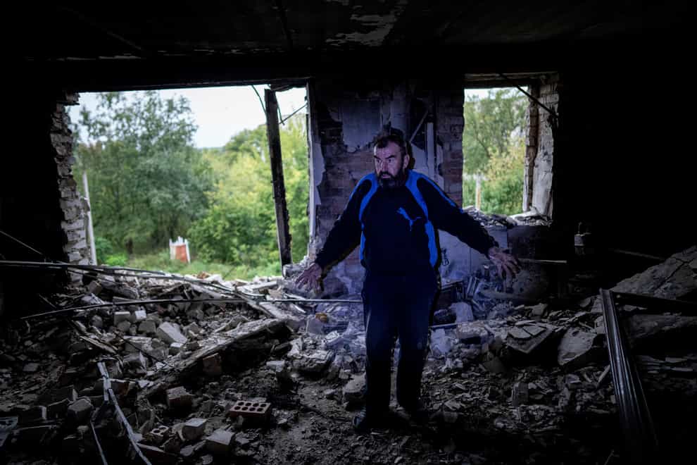 Andrii Iezyk shows the destroyed flat in his house in the recently retaken area of Izium, Ukraine (AP)