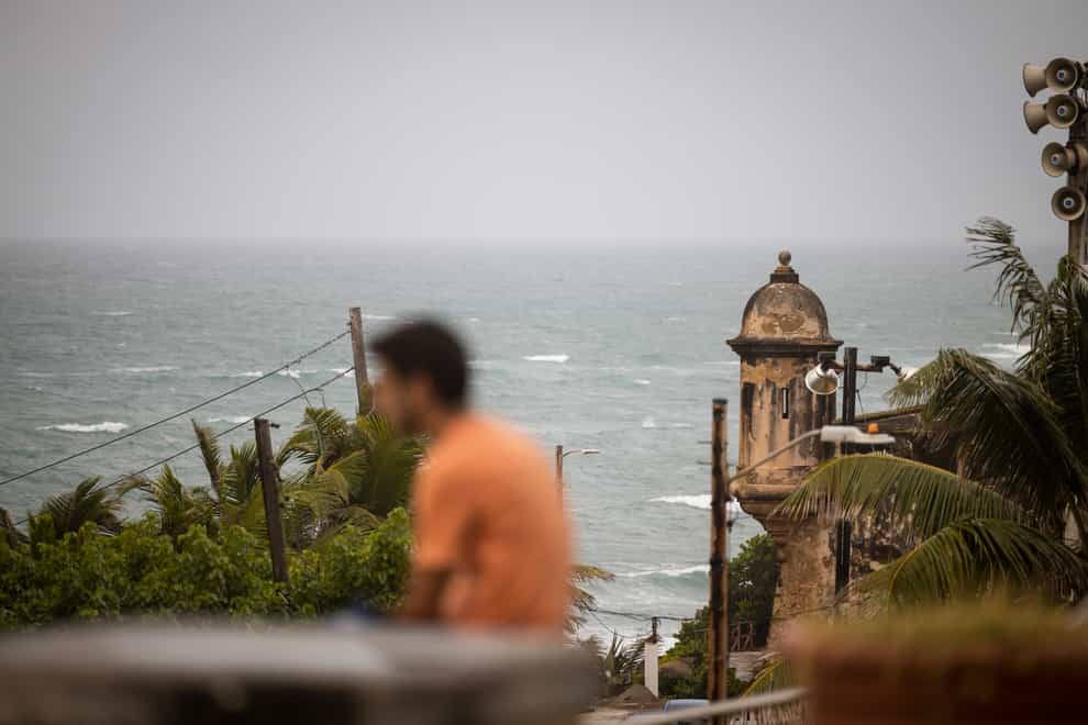 A man at a beach in San Juan, Puerto Rico, ahead of the arrival of Tropical Storm Fiona (Alejandro Granadillo/AP)