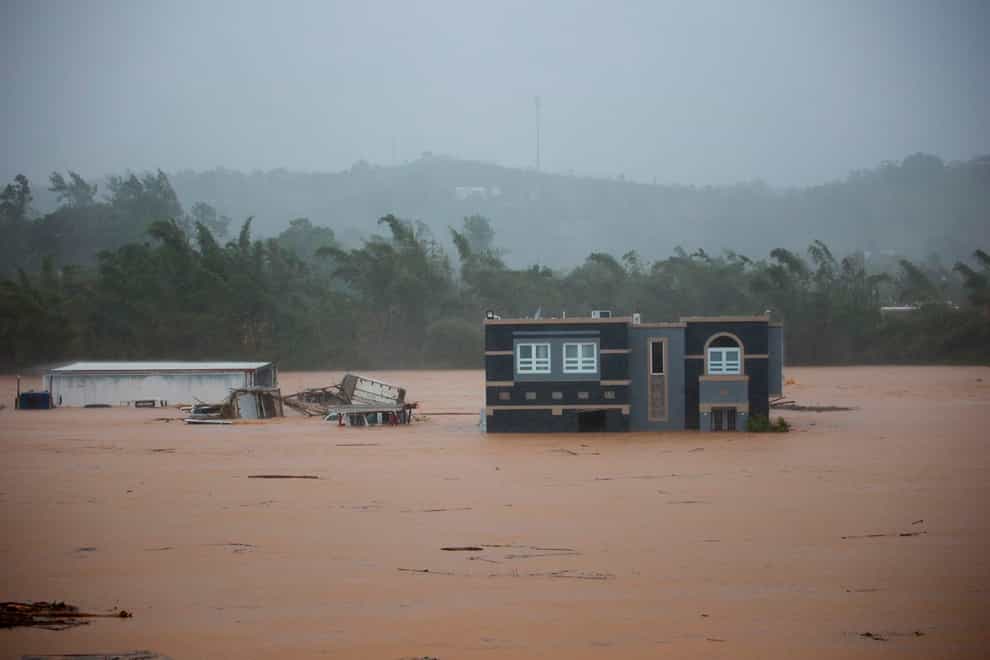 A home is submerged in floodwaters caused by Hurricane Fiona in Cayey, Puerto Rico (Stephanie Rojas/AP)