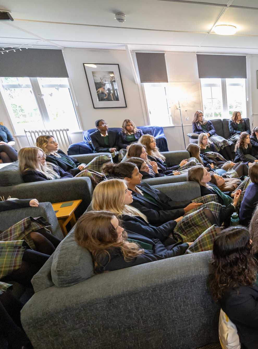 Students watch the state funeral of Queen Elizabeth II in their boarding house, Windmill Lodge, at Gordonstoun School (Paul Campbell/PA)