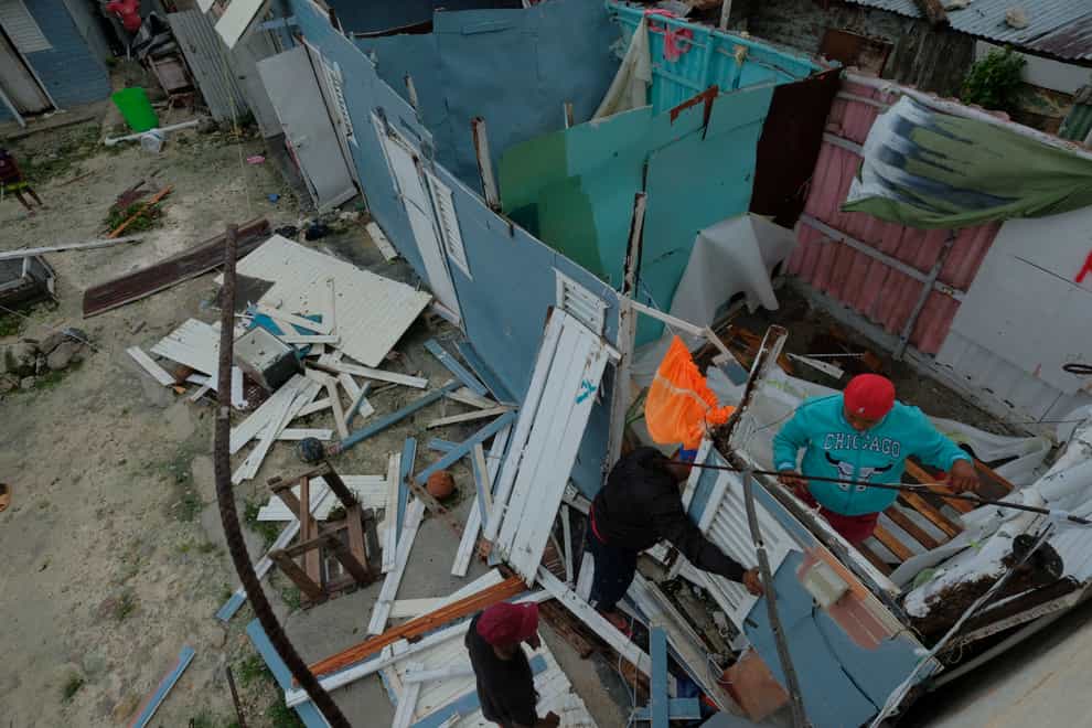 Residents replace a home’s roof that was torn off by Hurricane Fiona in the low-income neighborhood of Kosovo in Veron de Punta Cana, Dominican Republic, Monday, Sept. 19, 2022. (AP Photo/Ricardo Hernandez)
