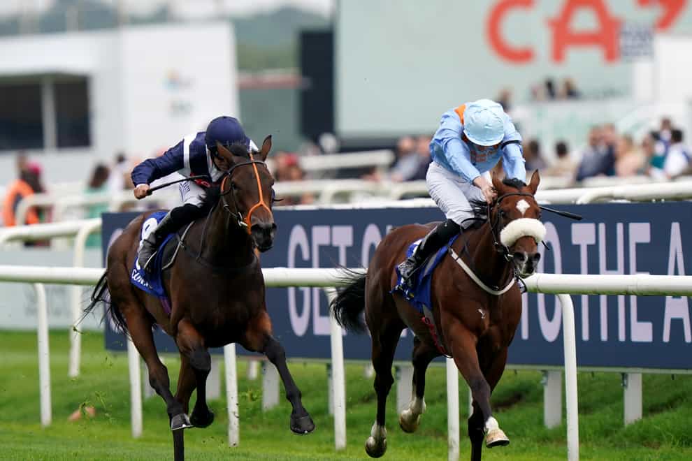 Trillium ridden by Pat Dobbs (left) passes The Platinum Queen ridden by Oisin Orr to win the Coral Flying Childers Stakes at Doncaster Racecourse (Tim Goode/PA)