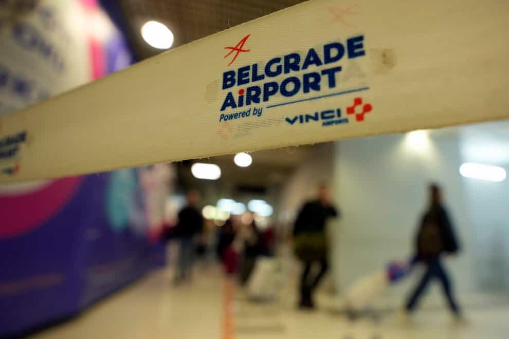 Passengers from a Moscow-Belgrade flight, operated by Air Serbia, pass through the airport building in Belgrade, Serbia (Darko Vojinovic/AP)