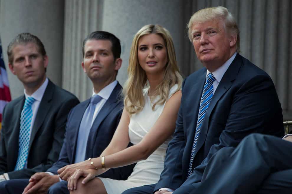 Donald Trump, right, sits with his children, from left to right, Eric, Donald Jr and Ivanka (Evan Vucci/AP)