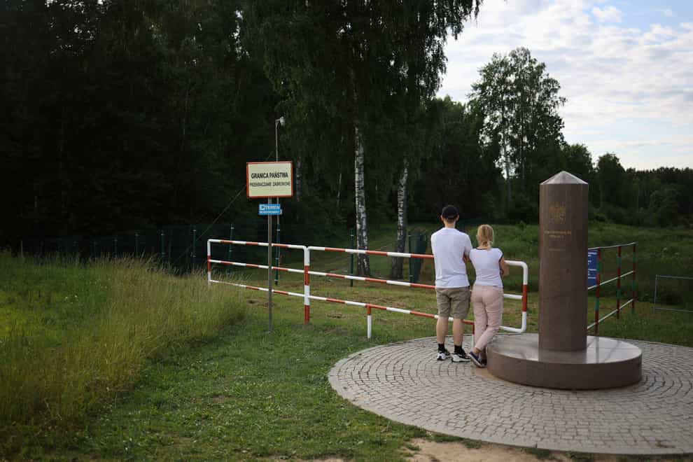 People visit the area of tripoint marking the place where borders of Poland, Lithuania and Russia’s Kaliningrad Oblast meet, in Zerdziny, Poland (Michal Dyjuk/AP)