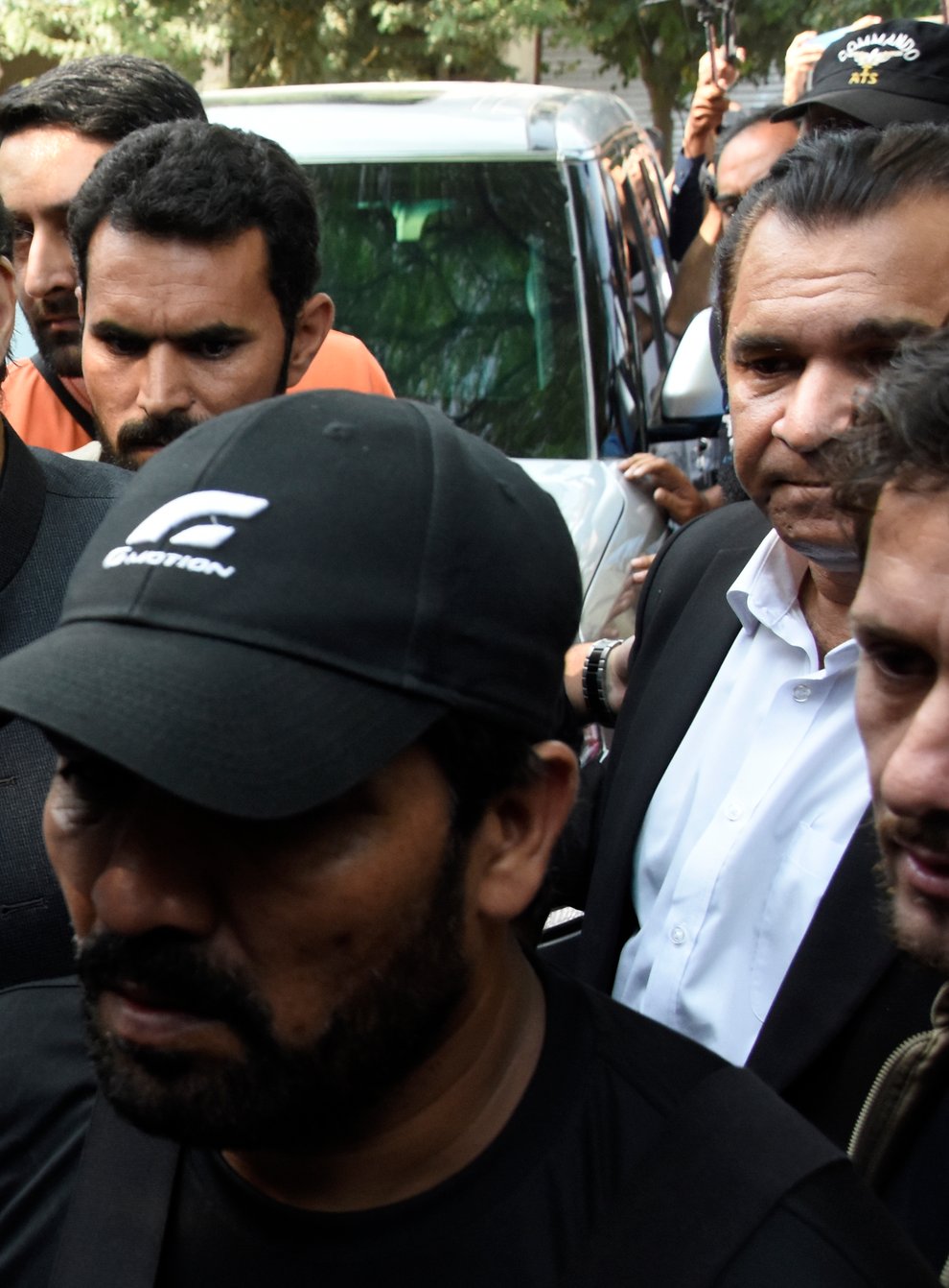 Former Pakistani Prime Minister Imran Khan, centre left, arrives to the Islamabad High Court surrounded by security in Islamabad, Pakistan (W.K. Yousafzai/AP)