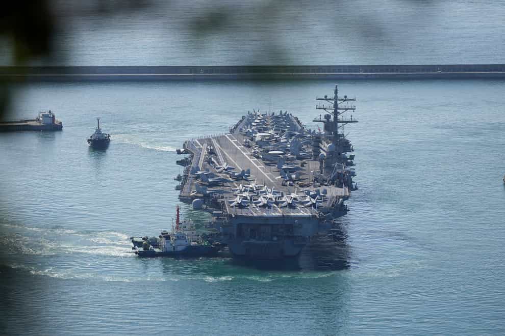 US aircraft carrier USS Ronald Reagan is escorted into Busan Naval Base (Lee Jin-man/AP)