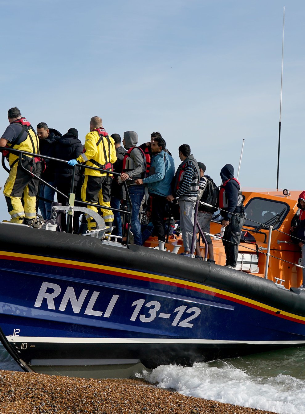 A group of people thought to be migrants arrive in Dungeness, Kent, after being rescued in the Channel by the RNLI (Gareth Fuller/PA Wire)