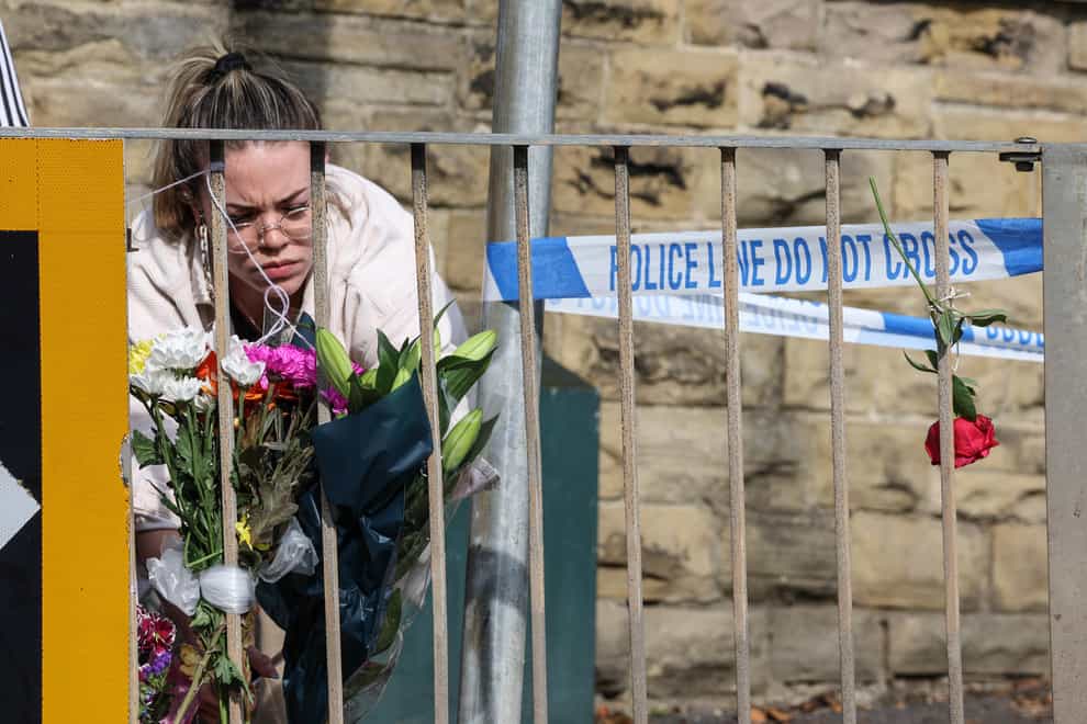 Floral tributes left near the scene in Woodhouse Hill, Huddersfield (Nigel Roddis/PA)