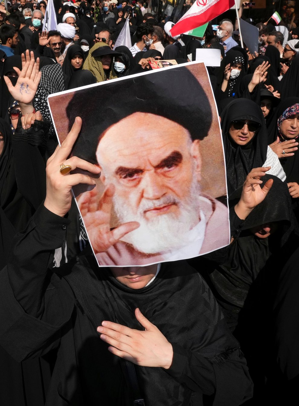 A pro-government demonstrator holds a poster of the late Iranian revolutionary founder Ayatollah Khomeini (Vahid Salemi/AP)