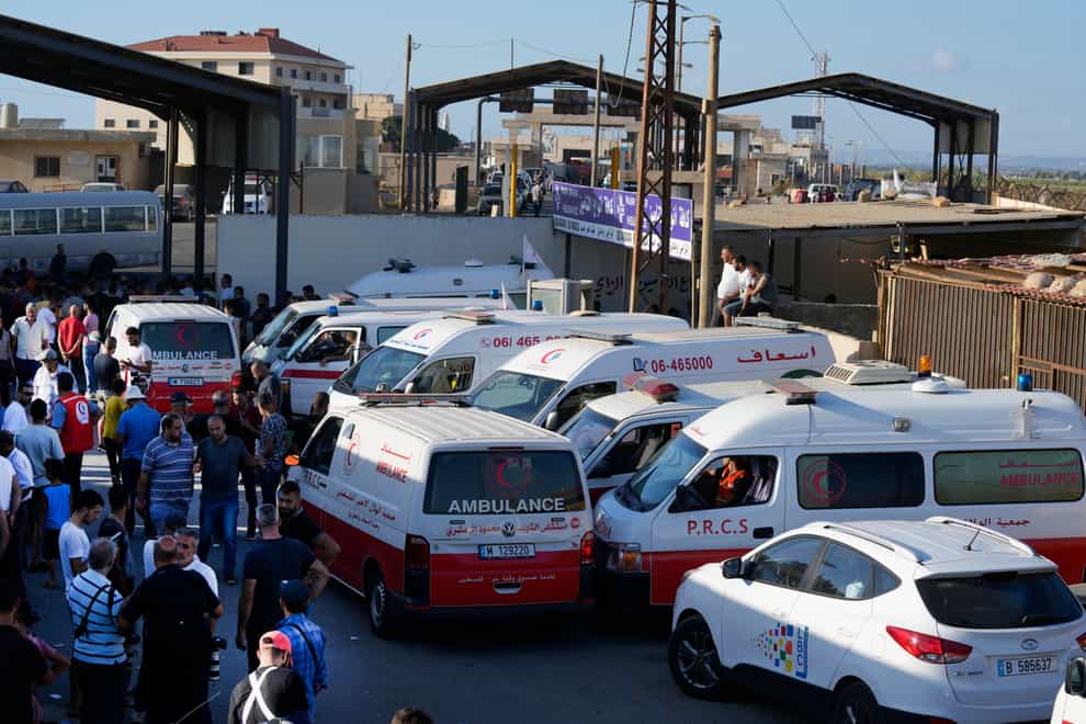 Lebanese and Palestinian ambulances wait at the site where the dead and survivors have been brought ashore (Bilal Hussein/AP)