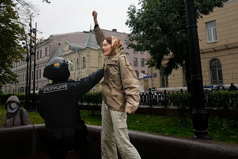 A police officer detains a demonstrator during a protest against a partial mobilisation in Moscow (AP Photo)
