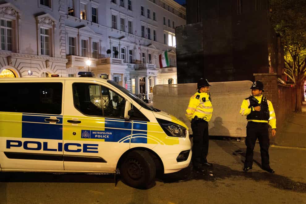 Police stand guard outside the Iranian Embassy in central London (Luke O’Reilly/PA)