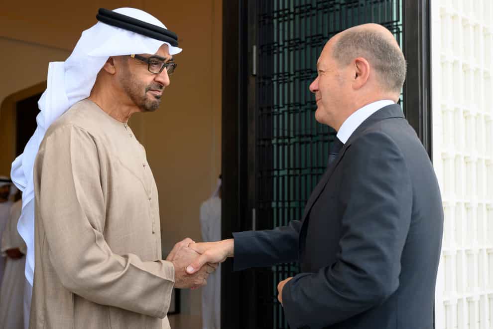 Sheikh Mohamed bin Zayed Al Nahyan, President of the UAE left, shakes hands with German Chancellor Olaf Scholz, at Al Shati Palace in Abu Dhabi on Sunday September 25 2022 (Mohamed Al Hammadi/UAE Presidential Court/AP)