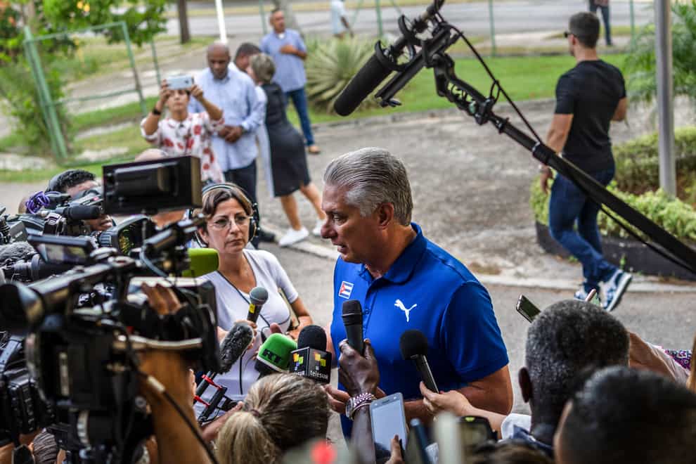 Cuba’s President Miguel Diaz Canel speaks to the press after casting his vote at a polling station (Ramon Espinosa/AP)