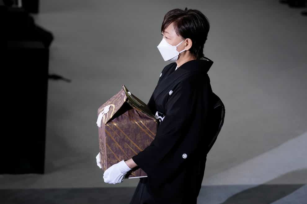 Akie Abe, widow of former prime minister Shinzo Abe, carries an urn containing his ashes at his state funeral (Franck Robichon/Pool/AP)