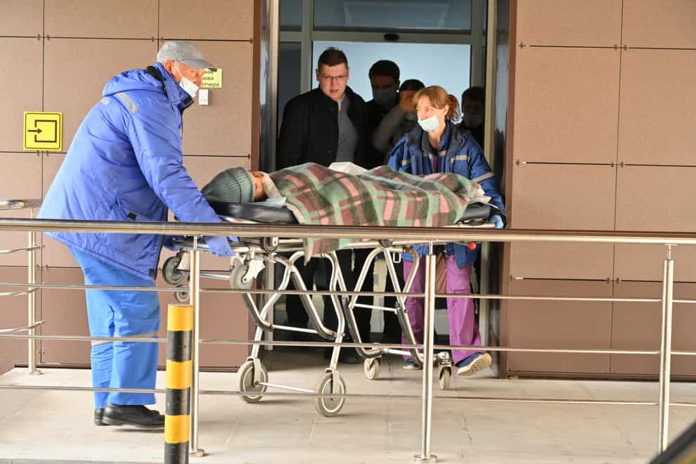 Medical staff carry an injured person on a stretcher at the emergency department of the First Republican Clinical hospital to evacuate to Moscow, in Izhevsk, Russia, Tuesday, Sept. 27, 2022. The plane of the Ministry of Emergency Situations will deliver victims of the shooting at school No. 88 in Izhevsk to Moscow hospitals. This was stated by the Presidential Commissioner for Children’s Rights Maria Lvova-Belova. According to officials, 11 children were among those killed in the Monday morning shooting in School No. 88 in Izhevsk, a city 960 kilometers (600 miles) east of Moscow. (AP Photo/Dmitry Serebryakov)