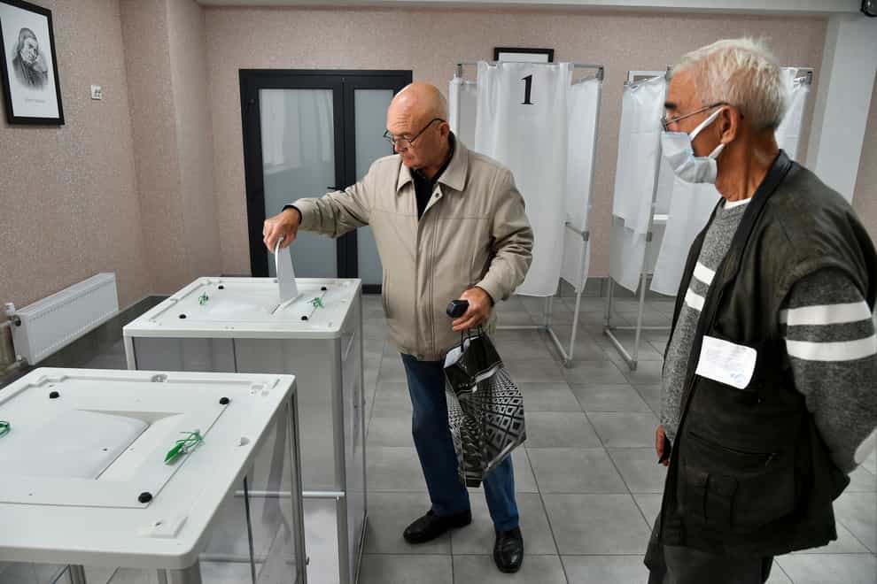 A man casts his ballot at a polling station during a referendum in Melitopol, Zaporizhzhia region (AP Photo)