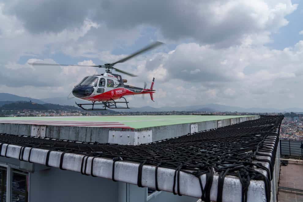 A rescue helicopter prepares to land at a hospital in Kathmandu, Nepal (Niranjan Shrestha/AP)