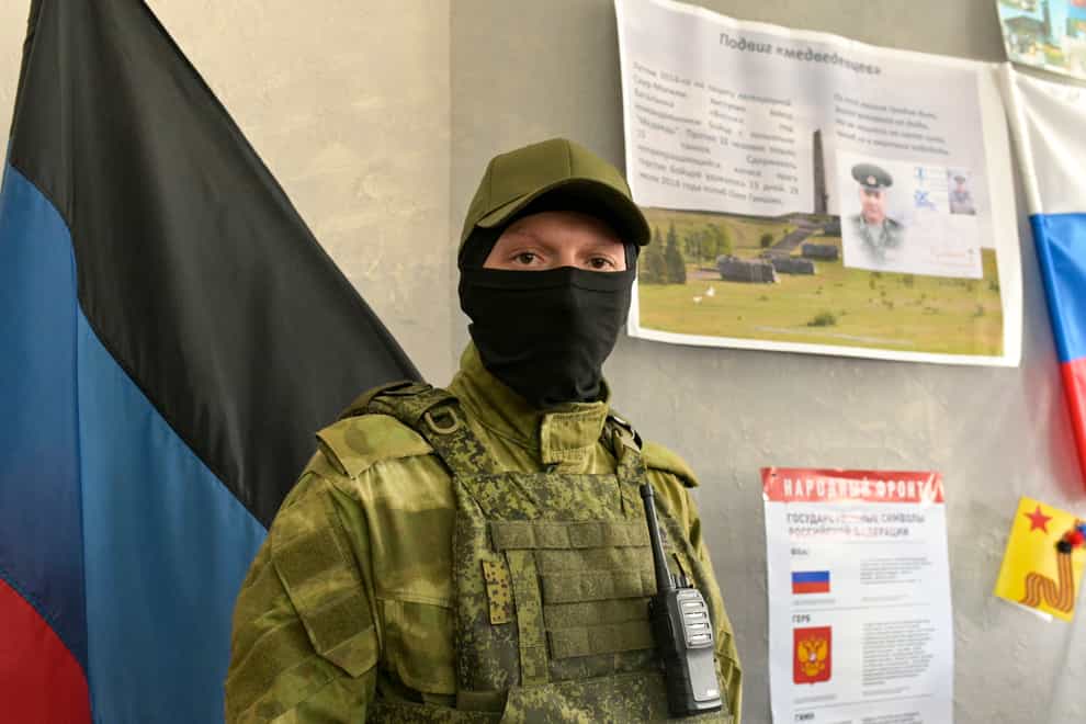 A Donetsk People’s Republic serviceman stands guard at a polling station prior to a referendum in Donetsk, Donetsk People’s Republic, controlled by Russia-backed separatists, eastern Ukraine (AP)