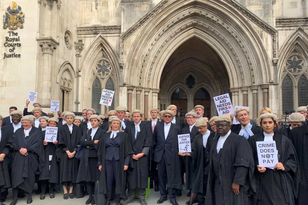 Criminal barristers from the Criminal Bar Association demonstrate outside the Royal Courts of Justice in London, as part of their ongoing pay row with the Government (Tom Pilgrim/PA)