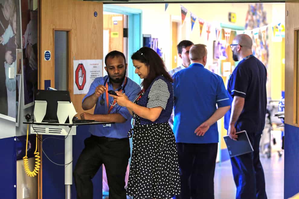 NHS staff are facing a cost-of-living crisis which is forcing them to leave for better paid jobs in shops and hospitality, according to the body that represents trusts (PA)