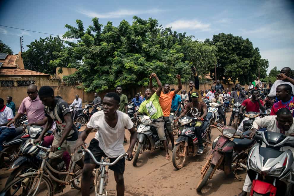 Young men chant slogans against the power of Lt Col Damiba, against France and pro-Russia, in Ouagadougou, Burkina Faso on Friday (Sophie Garcia/AP)