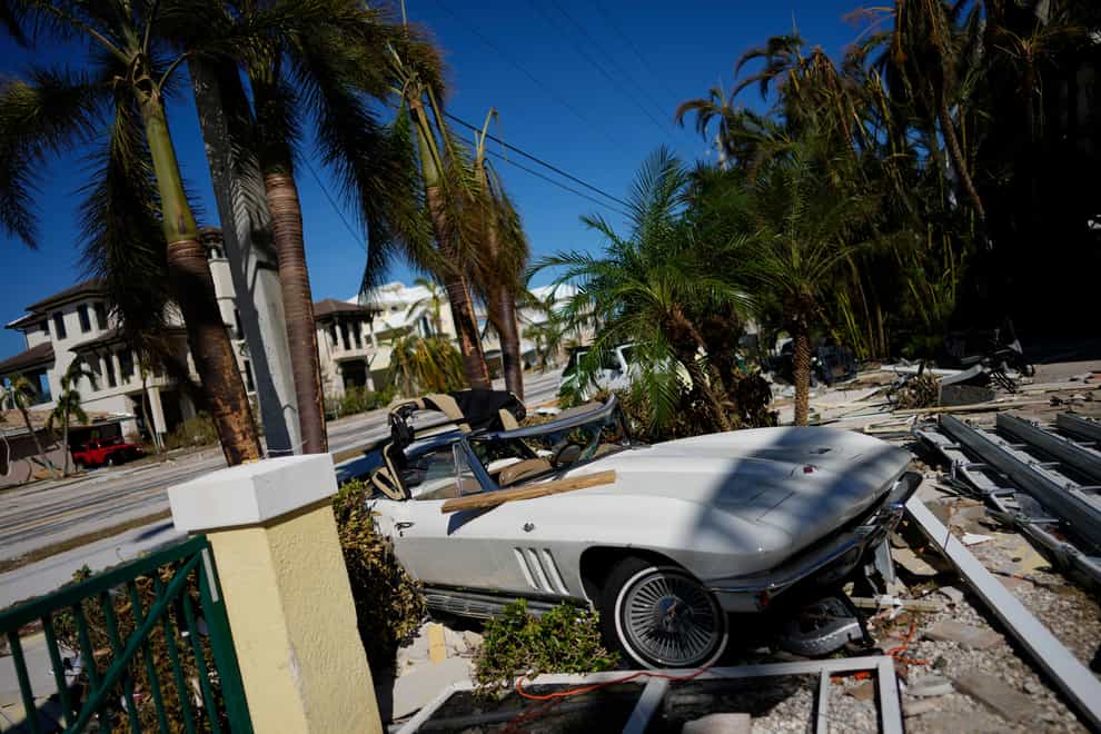 A classic sports car sits where it landed during the passage of Hurricane Ian in Fort Myers Beach, Flordia (Rebecca Blackwell/AP/PA)
