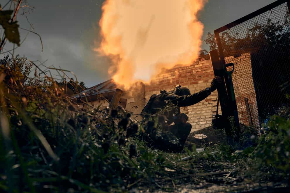 Ukrainian soldiers fire in the recently retaken Kupiansk in the Kharkiv region (AP)