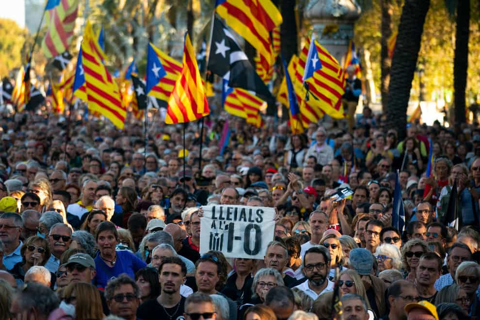 Protesters hold Catalonia independence flags as they take part in a demonstration (AP)