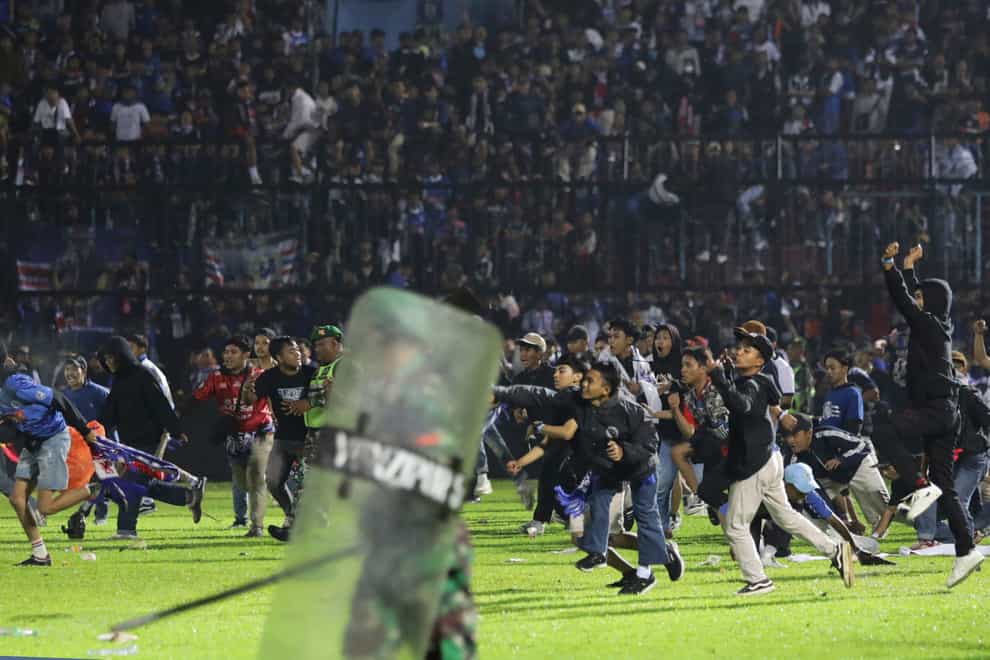Fans enter the pitch (AP Photo/Yudha Prabowo)