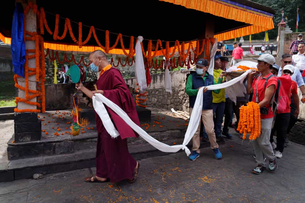 Buddhist monks perform rituals during the funeral of American extreme skier Hilaree Nelson in Kathmandu, Nepal, (Niranjan Shrestha/AP)