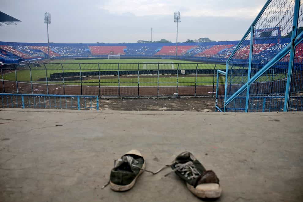 Panic at an Indonesian football match after police fired tear gas to to disperse supporters invading the pitch left more than 170 people dead, mostly trampled to death, police said (Hendra Permana/AP)