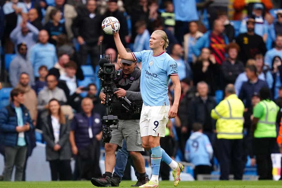 Manchester City’s Erling Haaland celebrates with the match ball following a 6-3 derby victory over Manchester United (Martin Rickett/PA)