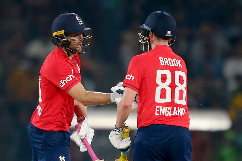 Dawid Malan, left, celebrates with teammate Harry Brook after scoring fifty during the seventh twenty20 cricket match between Pakistan and England (K.M. Chaudary/AP)